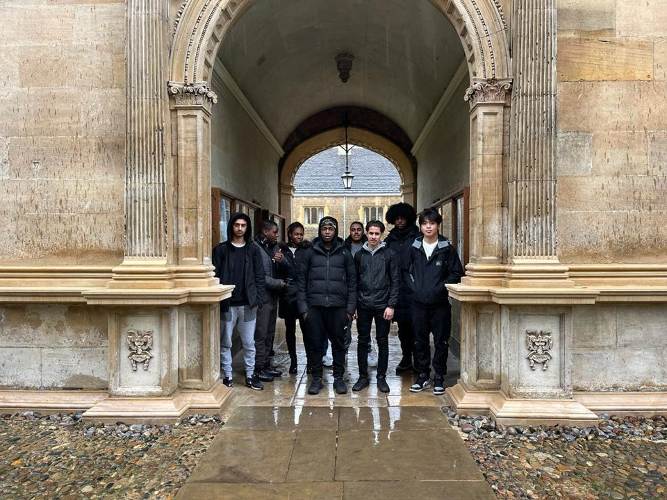 Group of students at Cambridge university under an arch