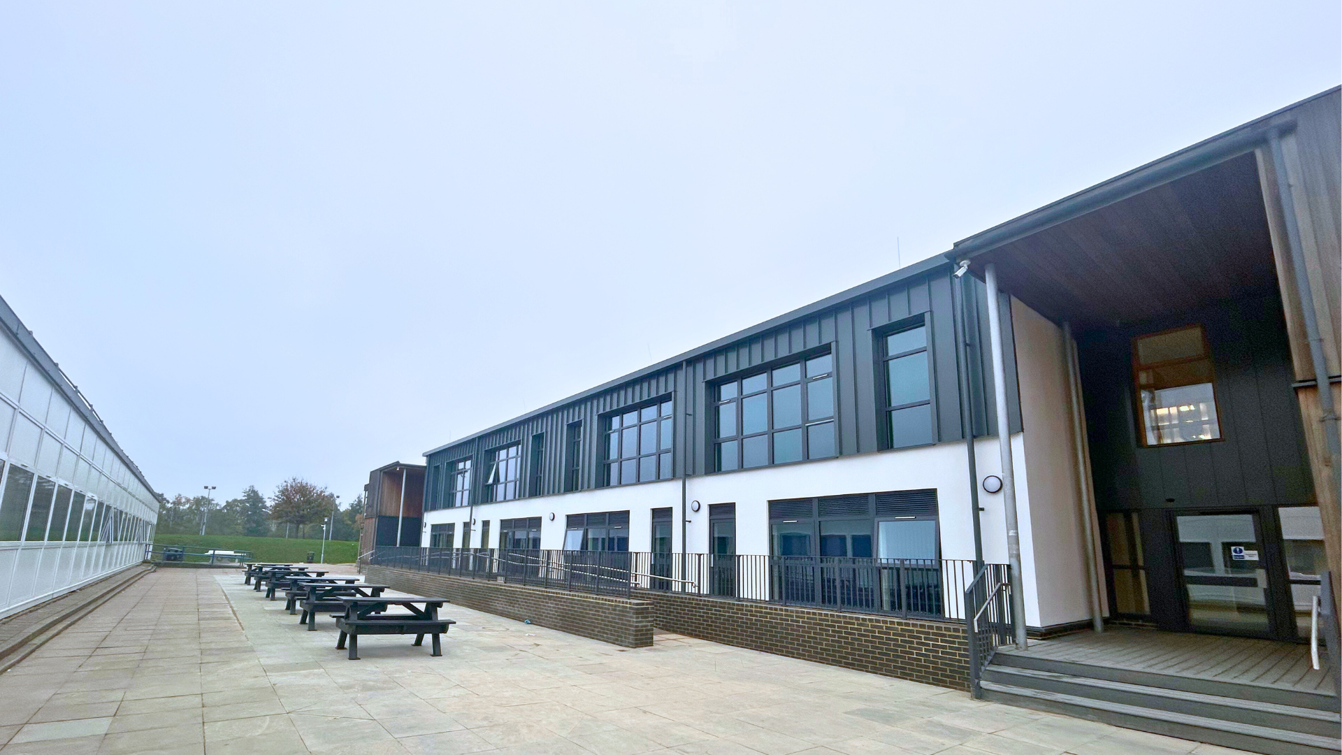 new post 16 building taken from the right capturing the benches as the front and the ramp